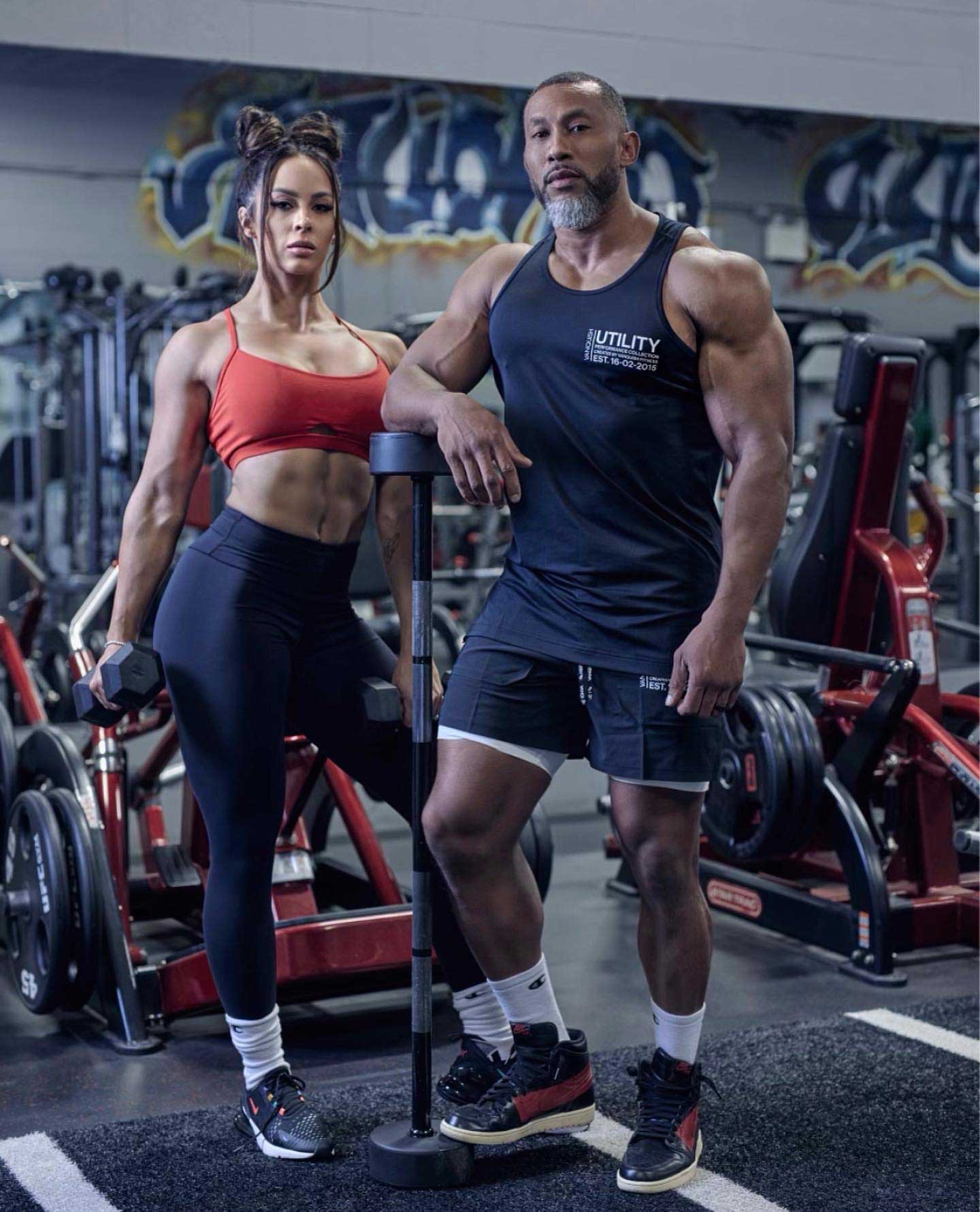 Coach and a client standing side by side in a gym